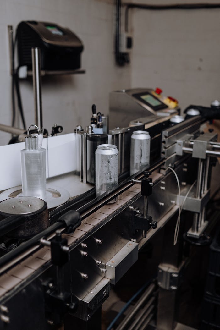 Services-03 Close-up view of an automated canning line in a brewery, showcasing modern manufacturing technology.